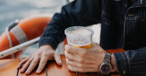 man drinking beer on a boat